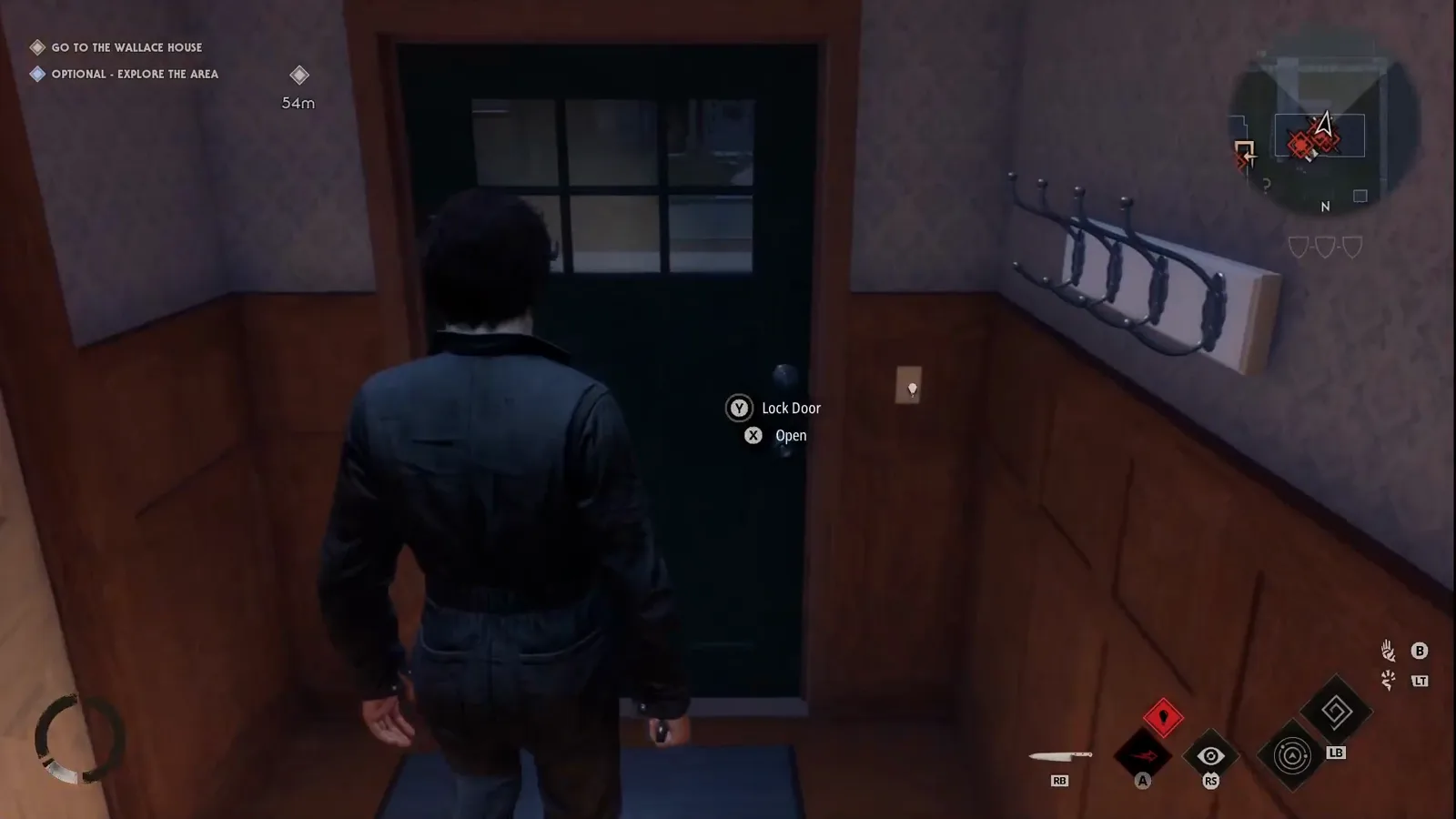 Michael Myers in dark coveralls facing a wood-panelled entryway door with Lock Door and Open prompts and a coat rack to the right while the Go to the Wallace House objective and a 54-metre marker show on screen